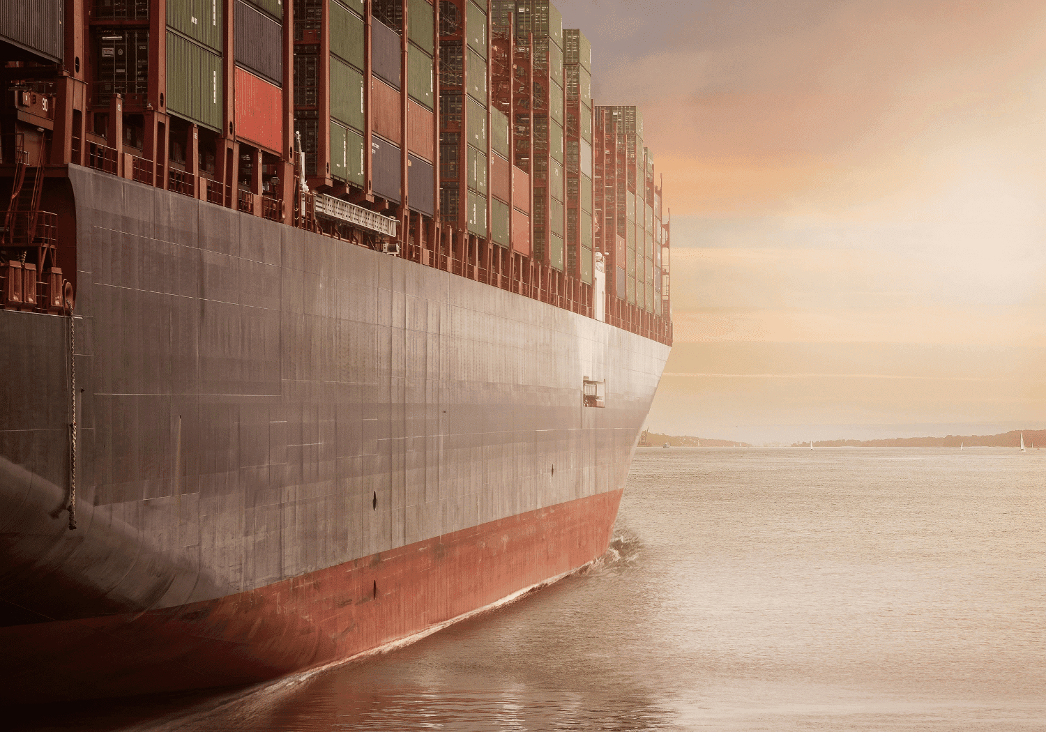 Fully laden container ship under way at dusk