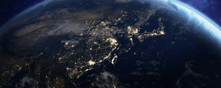 The curve of the Earth at night with city lights tracing the continents